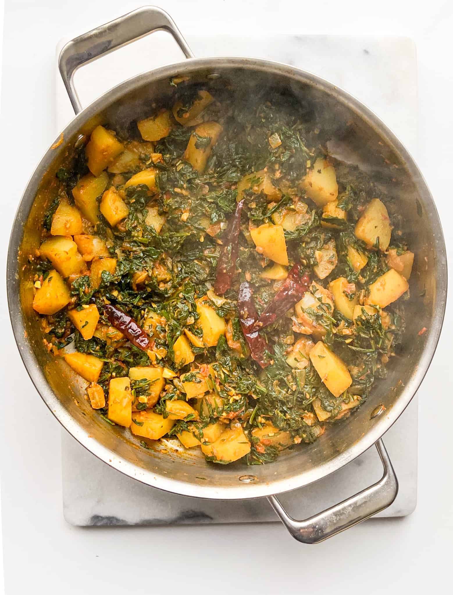 mix the wilted spinach and cook until spinach is tender.