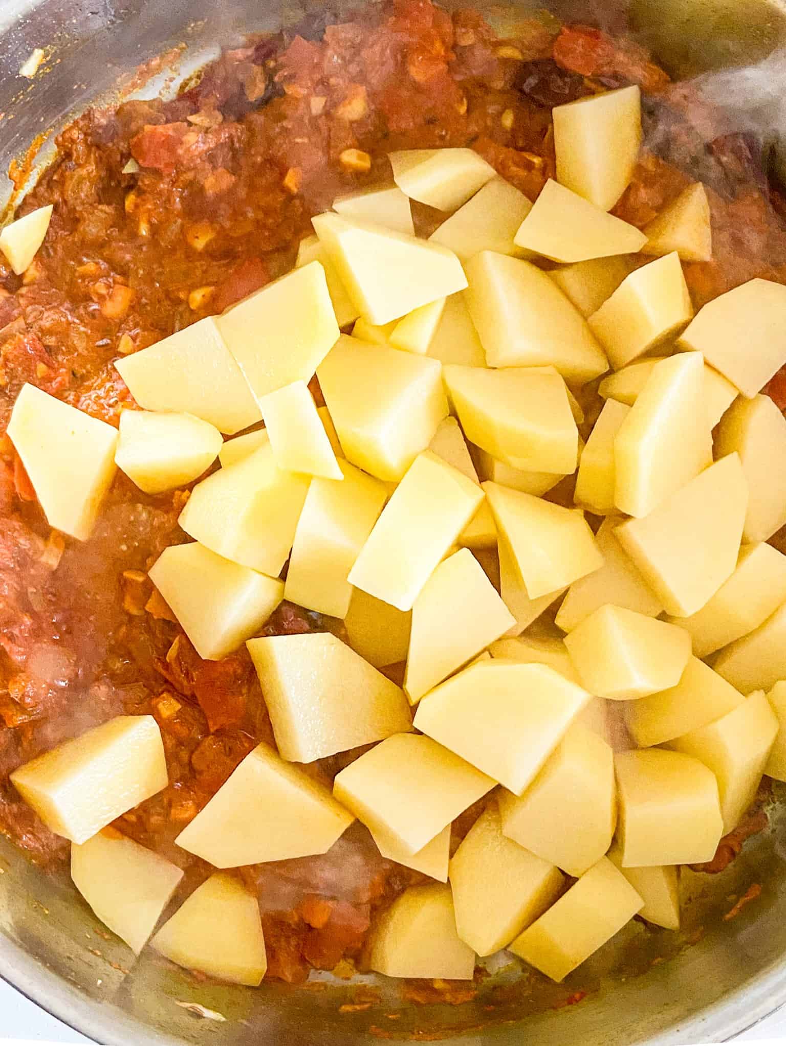 add cubed potatoes to the curry and cook until soft.
