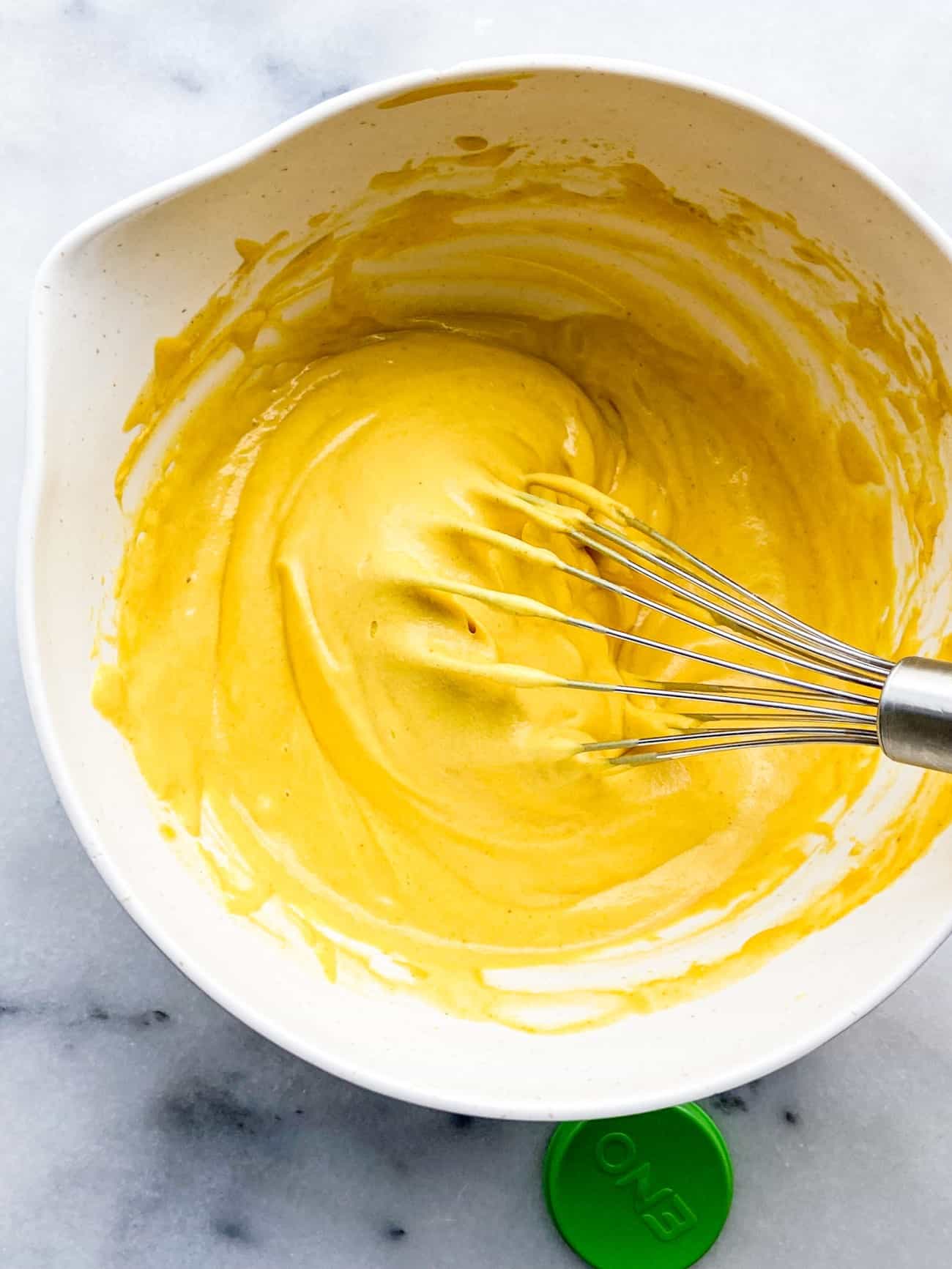 a bowl with yellow batter
