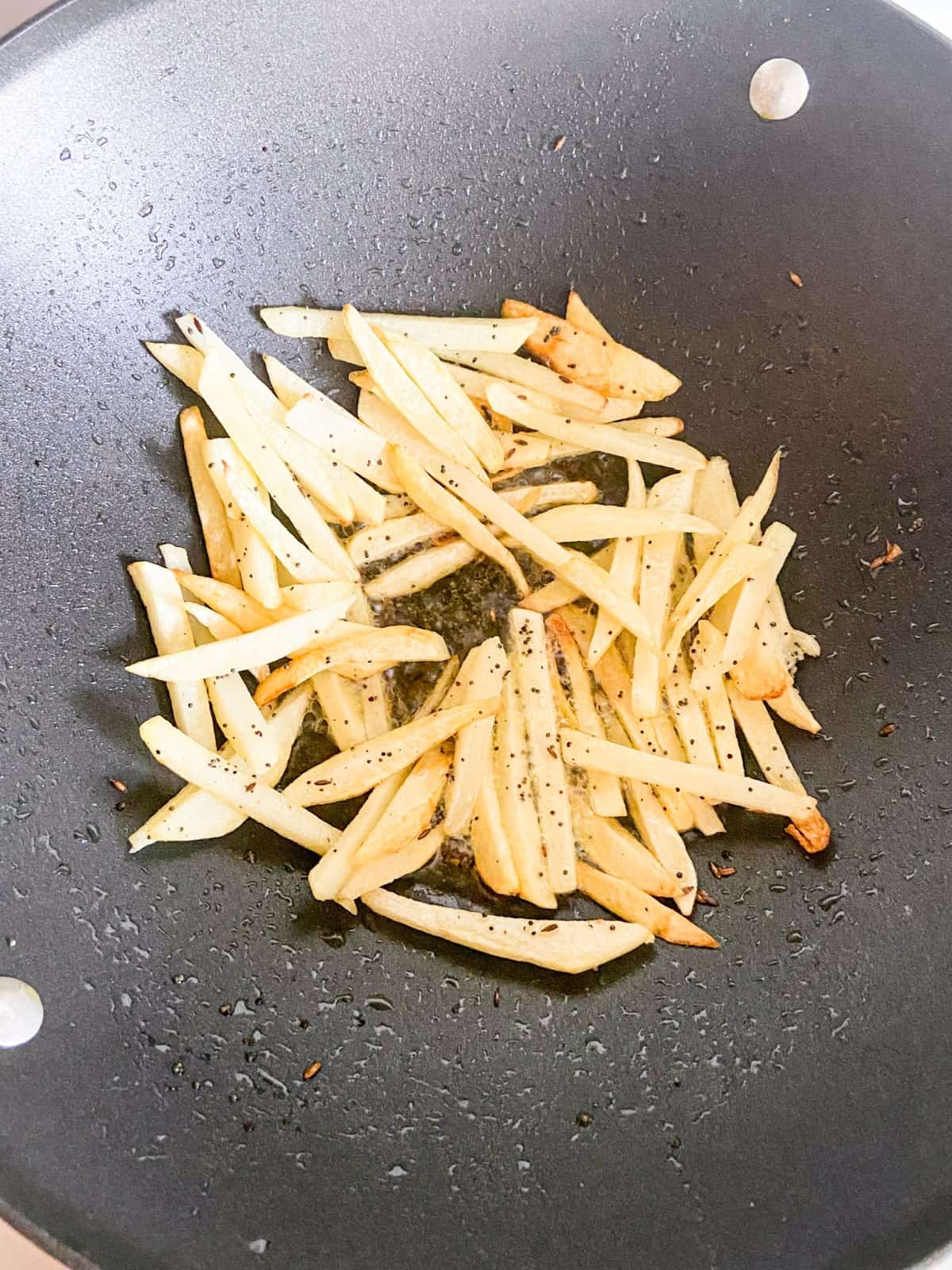 golden potato fries in a wok