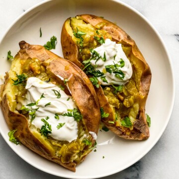 baked sweet potatoes with roasted chile and sour cream in a bowl