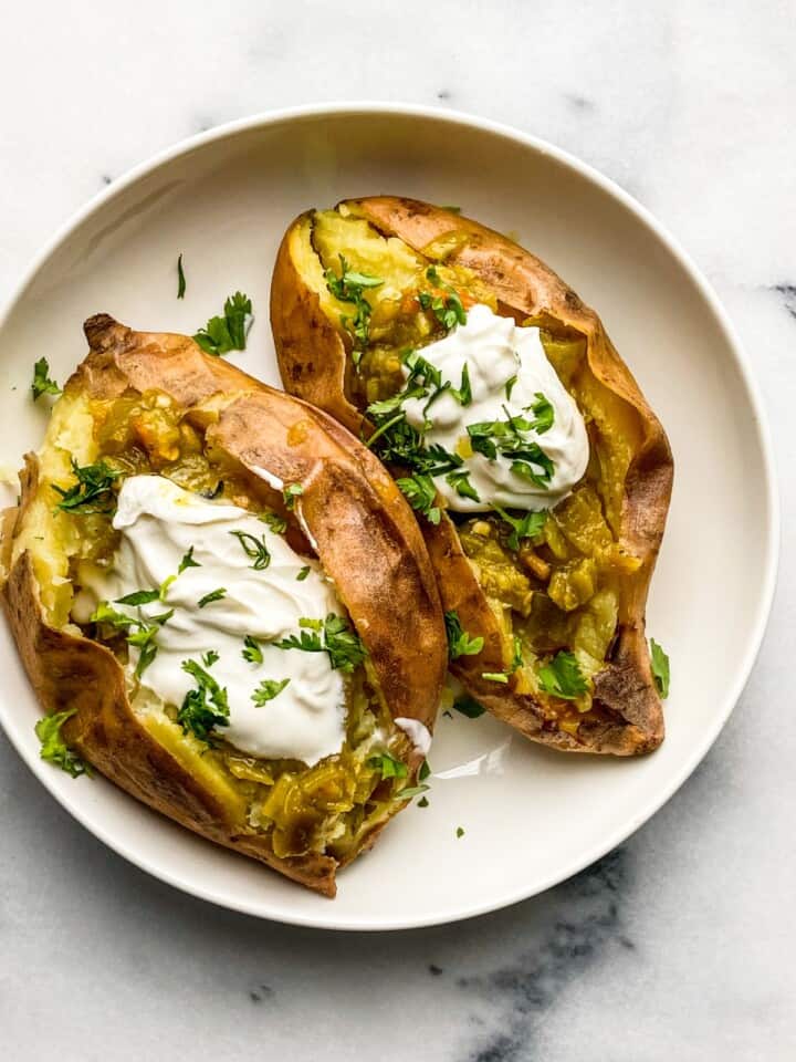 baked sweet potatoes with roasted chile and sour cream in a bowl