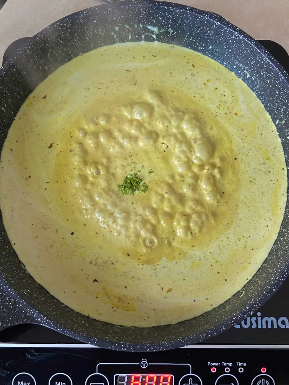 yellow sauce simmering in a pan