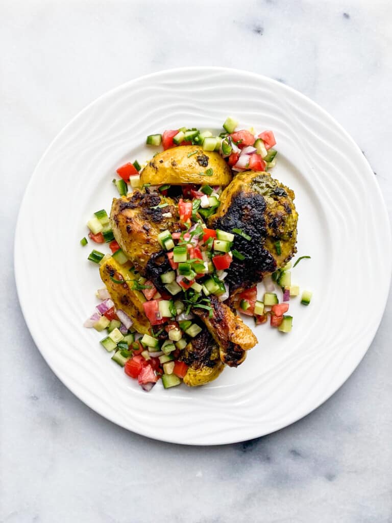 Chicken, potatoes and red and green salad