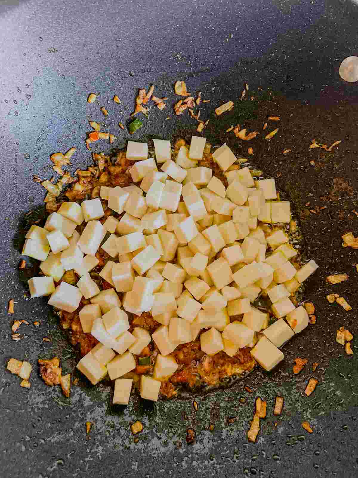 Paneer cubes added to tomato masala