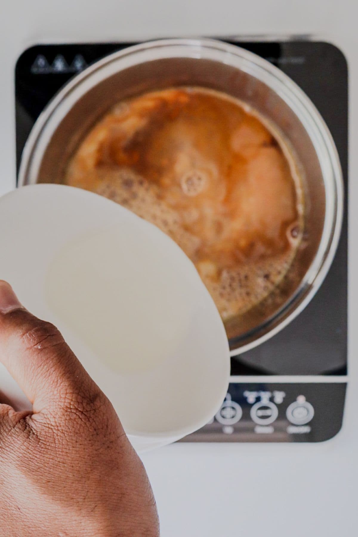 Adding milk to chai tea while it boils