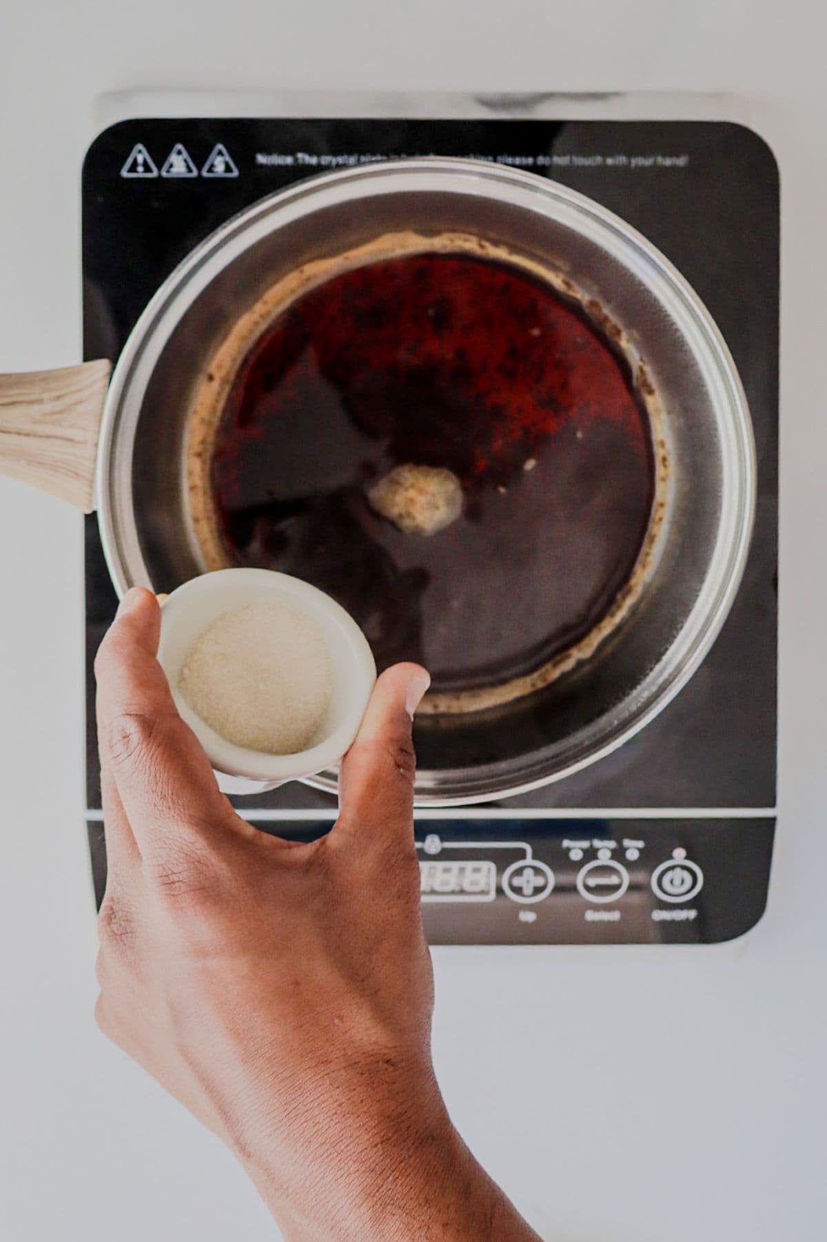 Adding sugar to Masala Chai while it boils