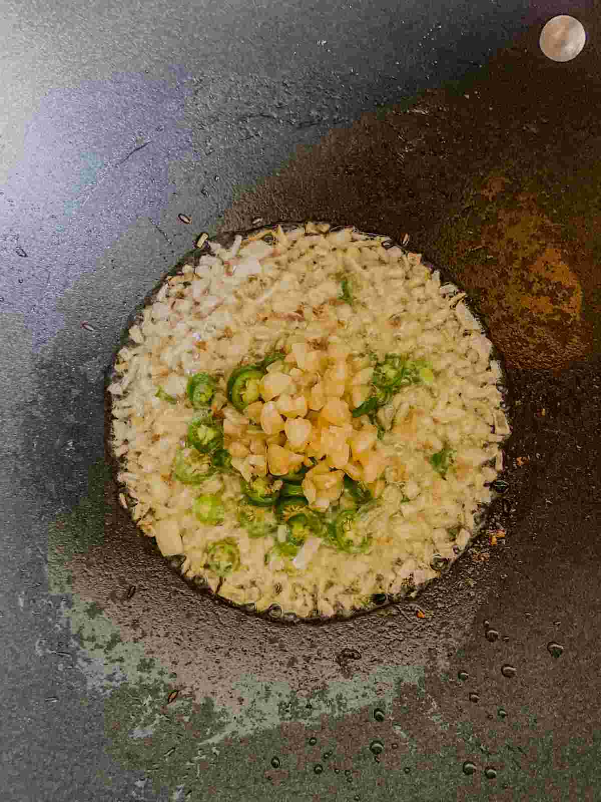 Cumin seeds, garlic and green chili added to sautéed onion