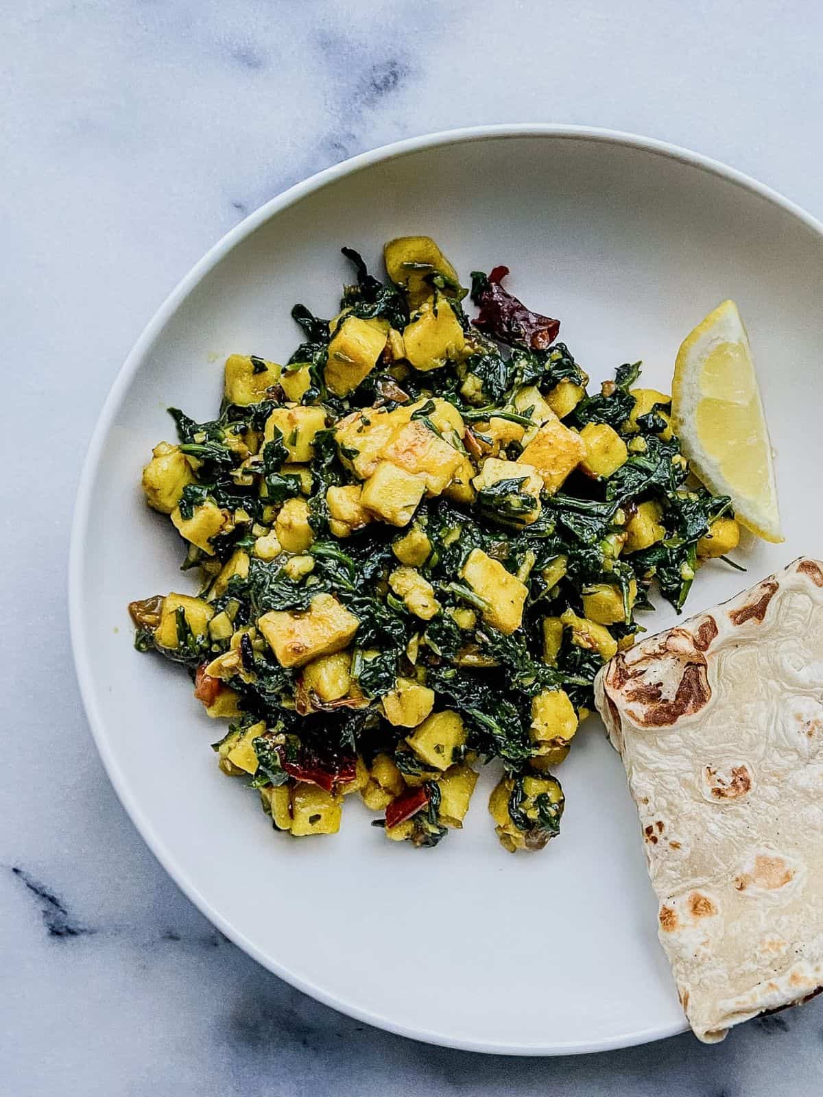 Dry palak paneer sabzi served with roti and lemon