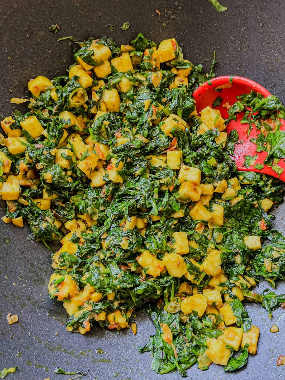 Finished dry palak paneer stir fry with spinach and paneer