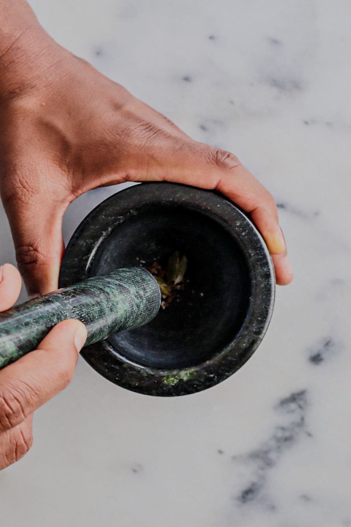 Grinding spices in a mortar and pestle