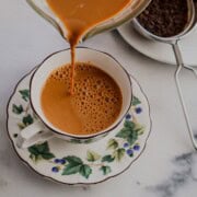 Pouring masala chai in a cup
