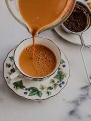 Pouring masala chai in a cup
