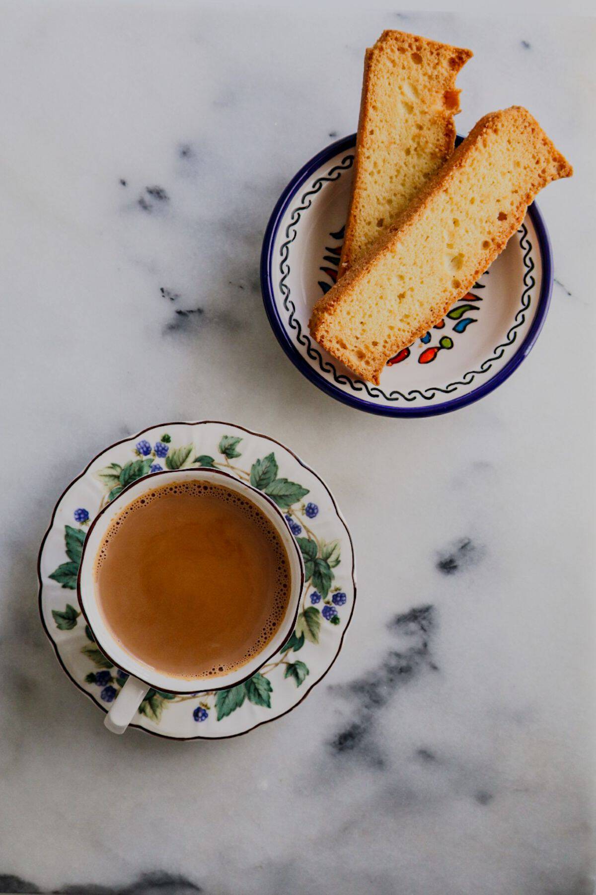 Chai served hot with crisp rusk on a plate